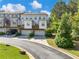 Well-manicured townhome complex with 2-car garages, wooden balconies, and professional landscaping at 3786 Alstead Manor Way, Suwanee, GA 30024