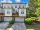 A home's exterior with a two-car garage and small balcony at 3786 Alstead Manor Way, Suwanee, GA 30024