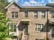 A well-maintained brick townhome showcases classic architectural details and an inviting entryway at 3786 Alstead Manor Way, Suwanee, GA 30024