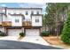 Beautiful townhome showcasing a two-car garage, a cozy balcony, and neat landscaping at 3786 Alstead Manor Way, Suwanee, GA 30024