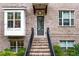 Charming brick townhome entrance featuring a stylish door, brick steps, and a bay window at 3786 Alstead Manor Way, Suwanee, GA 30024