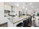 Open-concept kitchen featuring stainless steel appliances, an island, and seamless flow to living area at 3786 Alstead Manor Way, Suwanee, GA 30024