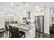 Modern kitchen with stainless steel appliances, granite countertops, and pendant lighting over the island at 3786 Alstead Manor Way, Suwanee, GA 30024