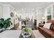 Spacious living room features hardwood floors and ample natural light, seamlessly flowing into dining area at 3786 Alstead Manor Way, Suwanee, GA 30024