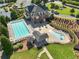 Aerial view of community pool, clubhouse, and kiddie pool surrounded by lounge chairs in a landscaped setting at 3786 Alstead Manor Way, Suwanee, GA 30024
