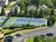 Lit tennis courts with players visible in a well-maintained community, parking and trees provide great location at 3786 Alstead Manor Way, Suwanee, GA 30024