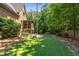 Expansive backyard featuring a lush lawn, mature trees, and a screened-in porch, perfect for outdoor entertaining at 504 S Westminster Ne Way, Atlanta, GA 30307