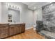 This bathroom features a glass-enclosed shower with marble-style tile, a granite countertop, and wood cabinets at 504 S Westminster Ne Way, Atlanta, GA 30307