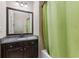 Bright bathroom features vanity with granite counters and a decorative shower curtain at 504 S Westminster Ne Way, Atlanta, GA 30307