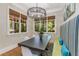 Cozy dining room featuring a modern light fixture, hardwood floors, and natural light from large windows at 504 S Westminster Ne Way, Atlanta, GA 30307