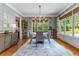 Formal dining room with gray wallpaper, hardwood floors, a modern chandelier and windows with a view at 504 S Westminster Ne Way, Atlanta, GA 30307