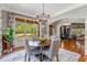 Dining room featuring grey decor, hardwood floors, a table, chairs and a modern light fixture at 504 S Westminster Ne Way, Atlanta, GA 30307