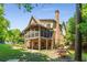 This backyard view highlights a two-story home with a screened porch and manicured landscaping at 504 S Westminster Ne Way, Atlanta, GA 30307