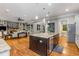 Open-concept kitchen with an island, stainless steel appliances, and hardwood floors open to the living room at 504 S Westminster Ne Way, Atlanta, GA 30307