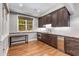 This kitchenette features granite countertops, dark wood cabinetry, and stainless steel appliances, including a beverage refrigerator at 504 S Westminster Ne Way, Atlanta, GA 30307