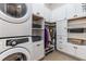 Well-organized laundry room with washer, dryer, cabinets, shelves, and storage space at 504 S Westminster Ne Way, Atlanta, GA 30307