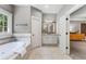 Bright bathroom with a soaking tub, walk-in shower, double vanity, and tiled floors at 504 S Westminster Ne Way, Atlanta, GA 30307