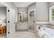 Luxurious bathroom with a soaking tub, walk-in shower, double vanity, and tiled floors at 504 S Westminster Ne Way, Atlanta, GA 30307