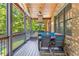 Enjoy outdoor dining on this screened porch featuring a grill, dining table, and ceiling fan at 504 S Westminster Ne Way, Atlanta, GA 30307