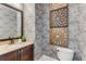 Stylish powder room with elegant wallpaper, granite countertop, and decorative art at 504 S Westminster Ne Way, Atlanta, GA 30307