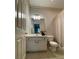 A well-lit bathroom with a vanity, toilet, and shower-tub combo at 937 Capitol View Nw Ave, Atlanta, GA 30318
