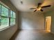 This is a carpeted bedroom with a ceiling fan and large window at 937 Capitol View Nw Ave, Atlanta, GA 30318