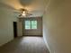 This is a carpeted bedroom with a ceiling fan and window at 937 Capitol View Nw Ave, Atlanta, GA 30318
