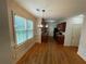 Cozy dining area adjacent to kitchen featuring beautiful hardwood floors, natural light, and a modern light fixture at 937 Capitol View Nw Ave, Atlanta, GA 30318