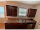 The kitchen sink features a stainless steel sink, dark cabinetry, and bright natural light from the window at 937 Capitol View Nw Ave, Atlanta, GA 30318