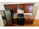 Practical kitchen space with stainless steel refrigerator, black appliances, and ample cabinet storage at 937 Capitol View Nw Ave, Atlanta, GA 30318