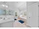 Bright bathroom features a shower, garden tub, double sinks, and tiled floors at 132 Shellbark Dr, Mcdonough, GA 30252
