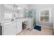 Modern bathroom features a glass enclosed shower, double vanity, and tiled floors at 132 Shellbark Dr, Mcdonough, GA 30252