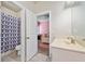 Bathroom features a shower with patterned curtain and a light-colored sink at 132 Shellbark Dr, Mcdonough, GA 30252