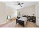Neutral bedroom features carpet and a ceiling fan and a black bed frame at 132 Shellbark Dr, Mcdonough, GA 30252