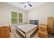 Neutral bedroom with natural light from a large window, suitable for a comfortable rest and relaxation at 132 Shellbark Dr, Mcdonough, GA 30252