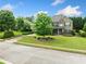 Charming brick home boasts a lush front yard and inviting curb appeal with mature trees enhancing its beauty at 132 Shellbark Dr, Mcdonough, GA 30252