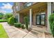 Elegant front entryway features a double door entry, complemented by manicured shrubs and classic brick facade at 132 Shellbark Dr, Mcdonough, GA 30252