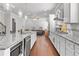 Modern kitchen with granite counters, stainless appliances, hardwood floors, and open to the living area at 132 Shellbark Dr, Mcdonough, GA 30252