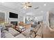 Spacious living room with fireplace, hardwood floors, ceiling fan and abundant natural light at 132 Shellbark Dr, Mcdonough, GA 30252