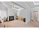 Cozy living room featuring a fireplace, neutral carpet, and crown molding at 132 Shellbark Dr, Mcdonough, GA 30252