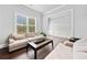 Bright living room features neutral decor, plush seating, and view to another room at 132 Shellbark Dr, Mcdonough, GA 30252