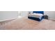 This bedroom has a large size and a blue bed frame and a neutral color walls at 132 Shellbark Dr, Mcdonough, GA 30252