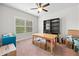 Bright office features a ceiling fan, natural light, and space for both a desk and storage shelving at 132 Shellbark Dr, Mcdonough, GA 30252