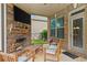 Charming outdoor living space with a stone fireplace, comfortable seating, and a peaceful backyard view at 132 Shellbark Dr, Mcdonough, GA 30252