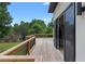Spacious outdoor wooden deck offering green backyard views through open sliding doors at 1610 Niskey Lake Rd, Atlanta, GA 30331