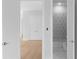 A modern bathroom with geometric-patterned wallpaper and hexagon tile flooring at 1610 Niskey Lake Rd, Atlanta, GA 30331