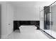 Elegant bathroom featuring a modern tub, sleek glass shower, and stylish black marble accents at 1610 Niskey Lake Rd, Atlanta, GA 30331