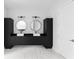 Dual vanity bathroom with modern sinks, sleek black cabinets and circular mirrors at 1610 Niskey Lake Rd, Atlanta, GA 30331