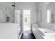 Bathroom boasts a modern vanity with dual sinks, granite counters, sleek mirrors, and a frameless glass shower at 1610 Niskey Lake Rd, Atlanta, GA 30331