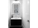 Modern powder room featuring an illuminated mirror and sleek black vanity at 1610 Niskey Lake Rd, Atlanta, GA 30331